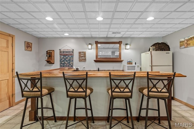 5090 Green Hills Rd, Festus, MO 63028 - indoor wet bar featuring white appliances, recessed lighting, and light tile patterned floors