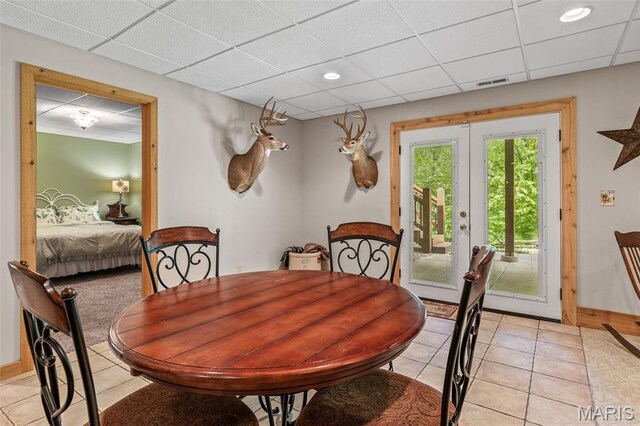 5090 Green Hills Rd, Festus, MO 63028 - dining space with light tile patterned floors, a paneled ceiling, french doors, and recessed lighting