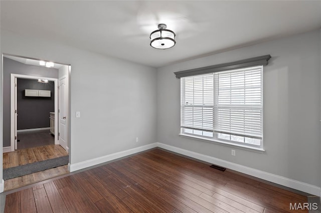 21 September St, Moscow Mills, MO 63362 - spare room featuring dark wood-type flooring and baseboards