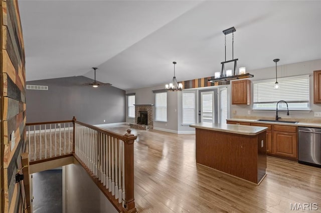 21 September St, Moscow Mills, MO 63362 - kitchen featuring a fireplace, dishwasher, light wood-type flooring, a center island, and vaulted ceiling