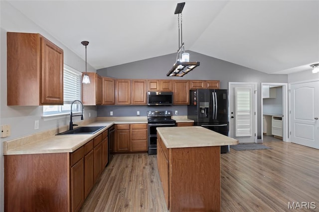 21 September St, Moscow Mills, MO 63362 - kitchen featuring black appliances, light countertops, light wood-style floors, vaulted ceiling, and decorative light fixtures