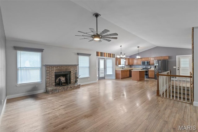 21 September St, Moscow Mills, MO 63362 - unfurnished living room featuring lofted ceiling, a chandelier, ceiling fan, light wood-style flooring, and a fireplace