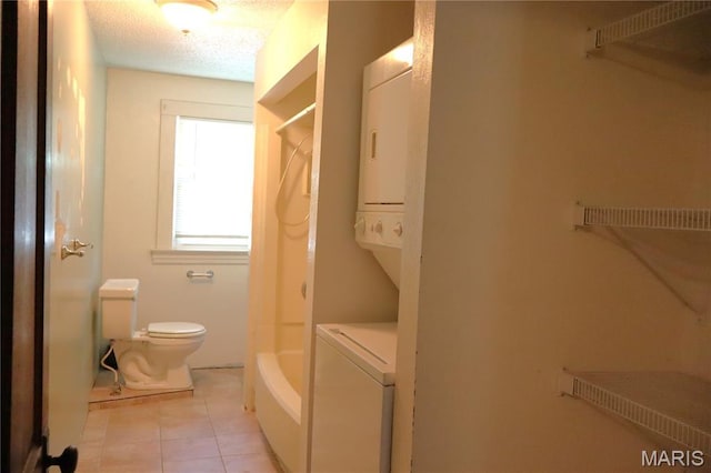616 Greensferry Rd, Jackson, MO 63755 - full bathroom with stacked washer / drying machine, tile patterned flooring, and a textured ceiling