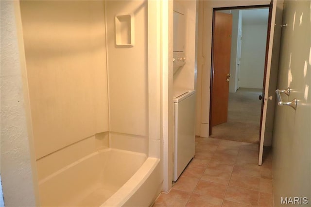 616 Greensferry Rd, Jackson, MO 63755 - bathroom featuring stacked washer / drying machine, tile patterned floors, and bathing tub / shower combination