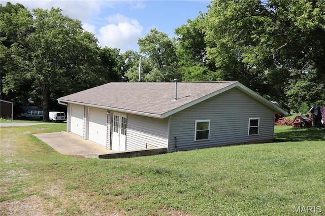 616 Greensferry Rd, Jackson, MO 63755 - back of house featuring a garage, a shingled roof, a lawn, and view of scattered trees