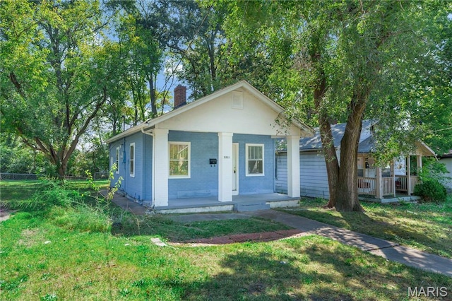 5316 Janet Ave, Jennings, MO 63136 - bungalow-style house featuring a porch, a chimney, and a front lawn