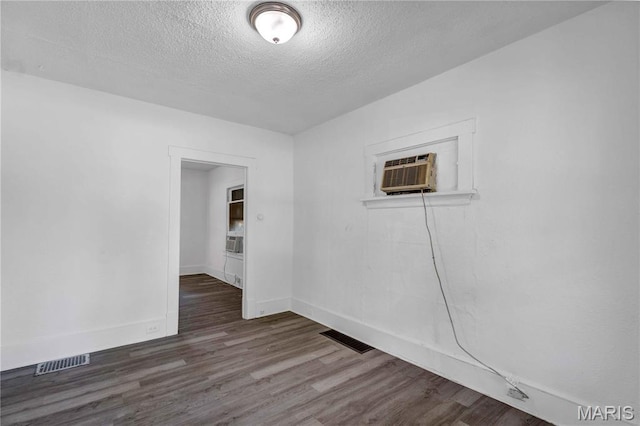 5316 Janet Ave, Jennings, MO 63136 - spare room with a textured ceiling, wood finished floors, a wall mounted AC, and cooling unit
