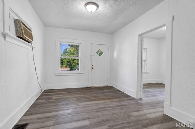 5316 Janet Ave, Jennings, MO 63136 - entryway with a textured ceiling, wood finished floors, and a wall mounted air conditioner