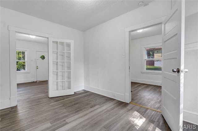 5316 Janet Ave, Jennings, MO 63136 - empty room with wood finished floors, a textured ceiling, and french doors