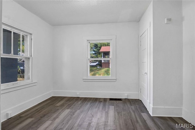 5316 Janet Ave, Jennings, MO 63136 - unfurnished room featuring dark wood-style floors and a textured ceiling