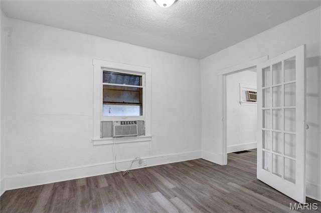 5316 Janet Ave, Jennings, MO 63136 - empty room featuring cooling unit, wood finished floors, a textured ceiling, and a wall mounted air conditioner