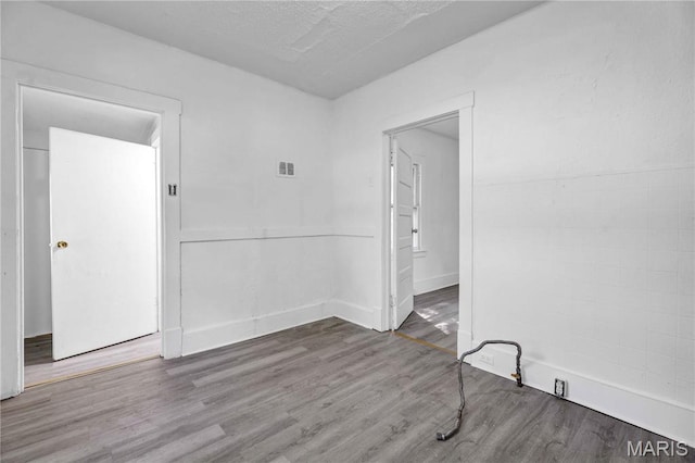5316 Janet Ave, Jennings, MO 63136 - empty room featuring wood finished floors and a textured ceiling