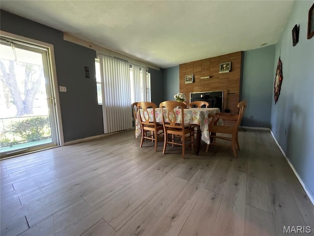 321 Walker St, Licking, MO 65542 - dining room with light wood finished floors, healthy amount of natural light, and a fireplace
