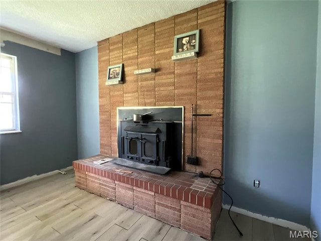 321 Walker St, Licking, MO 65542 - detailed view of a wood stove, a textured ceiling, and wood finished floors