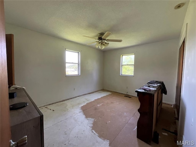 321 Walker St, Licking, MO 65542 - unfurnished bedroom with multiple windows, a textured ceiling, and ceiling fan