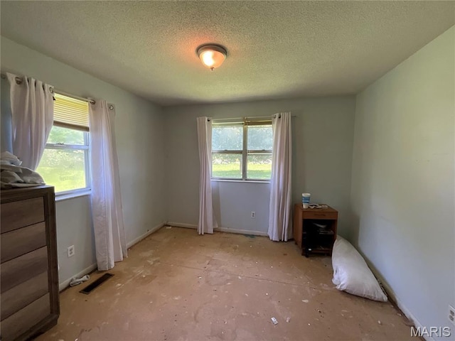 321 Walker St, Licking, MO 65542 - unfurnished bedroom with multiple windows and a textured ceiling
