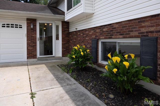 1715 Foxglove Dr, Saint Charles, MO 63303 - doorway to property featuring brick siding, concrete driveway, and a garage
