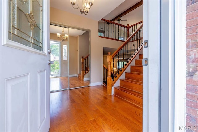 1715 Foxglove Dr, Saint Charles, MO 63303 - entrance foyer featuring a chandelier, wood finished floors, stairs, ceiling fan, and beam ceiling