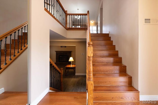 1715 Foxglove Dr, Saint Charles, MO 63303 - stairway featuring a towering ceiling and wood finished floors
