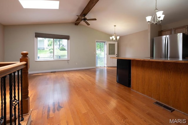 1715 Foxglove Dr, Saint Charles, MO 63303 - kitchen featuring a chandelier, freestanding refrigerator, light wood finished floors, a ceiling fan, and decorative light fixtures