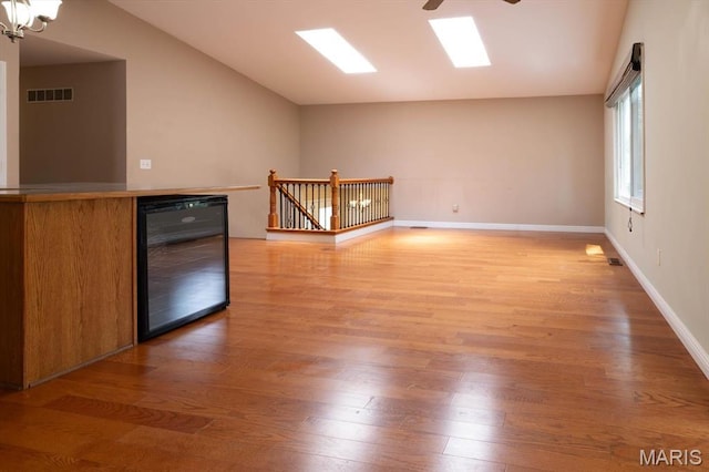 1715 Foxglove Dr, Saint Charles, MO 63303 - spare room featuring light wood-style flooring, a ceiling fan, and vaulted ceiling