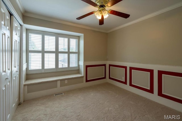 1715 Foxglove Dr, Saint Charles, MO 63303 - spare room featuring crown molding, carpet, a wainscoted wall, a ceiling fan, and a decorative wall