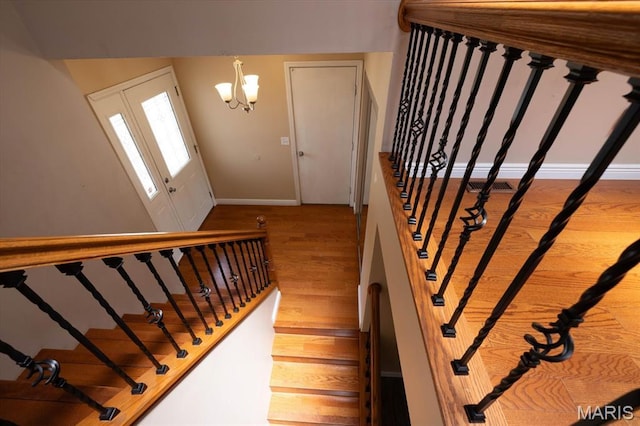 1715 Foxglove Dr, Saint Charles, MO 63303 - stairway featuring wood finished floors and a chandelier