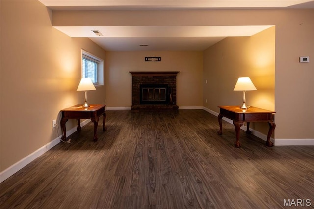 1715 Foxglove Dr, Saint Charles, MO 63303 - unfurnished living room with dark wood-type flooring and a fireplace