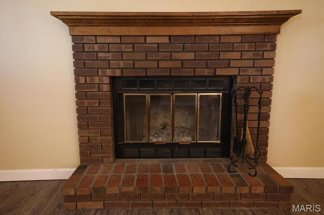 1715 Foxglove Dr, Saint Charles, MO 63303 - detailed view of a brick fireplace and wood finished floors