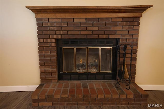 1715 Foxglove Dr, Saint Charles, MO 63303 - detailed view of a brick fireplace and wood finished floors