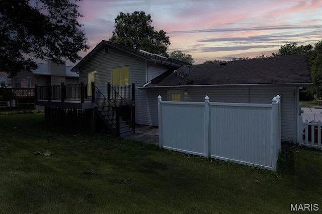 1715 Foxglove Dr, Saint Charles, MO 63303 - back of house at dusk featuring stairs and a wooden deck