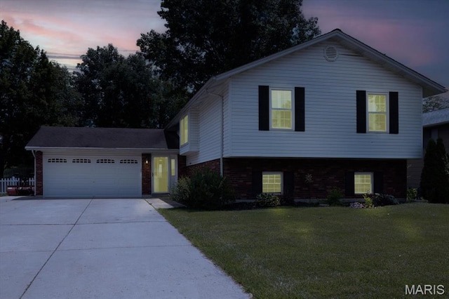 1715 Foxglove Dr, Saint Charles, MO 63303 - split level home featuring brick siding, concrete driveway, a garage, and a front lawn