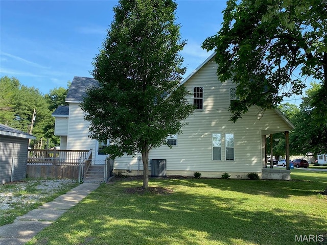 201 N Vine St, Nokomis, IL 62075 - view of side of property featuring a lawn and a wooden deck