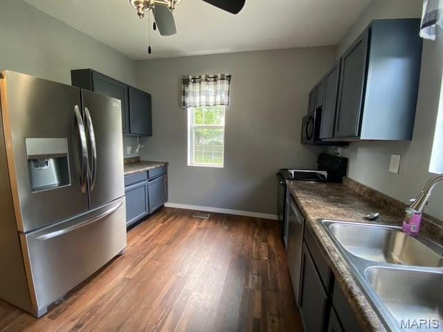 201 N Vine St, Nokomis, IL 62075 - kitchen with appliances with stainless steel finishes, a ceiling fan, and wood finished floors