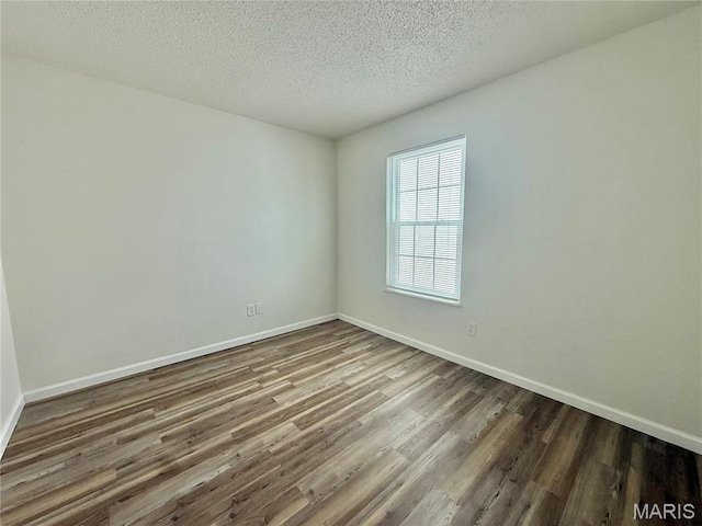 601 N Monroe St Unit 9, Pacific, MO 63069 - empty room with wood finished floors and a textured ceiling