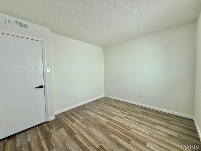 601 N Monroe St Unit 9, Pacific, MO 63069 - unfurnished room featuring wood finished floors and a textured ceiling