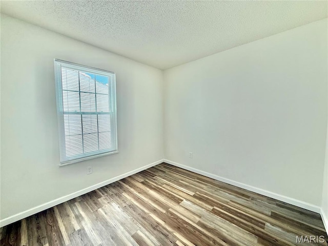 601 N Monroe St Unit 9, Pacific, MO 63069 - spare room featuring wood finished floors and a textured ceiling