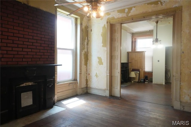 3632 Cook Ave, Saint Louis, MO 63113 - unfurnished dining area featuring wood finished floors, ceiling fan, and a fireplace