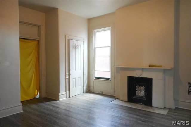3632 Cook Ave, Saint Louis, MO 63113 - unfurnished living room with wood finished floors and a fireplace with flush hearth
