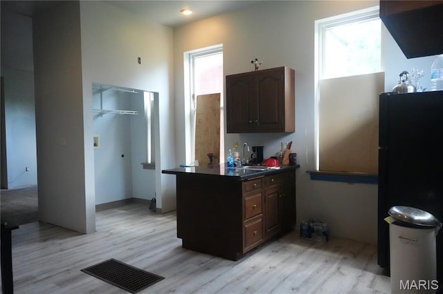3632 Cook Ave, Saint Louis, MO 63113 - kitchen featuring light wood-type flooring and dark countertops