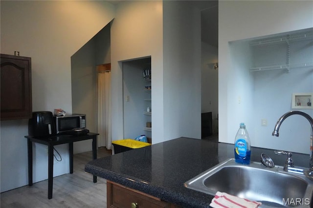 3632 Cook Ave, Saint Louis, MO 63113 - kitchen featuring dark countertops and light wood-type flooring