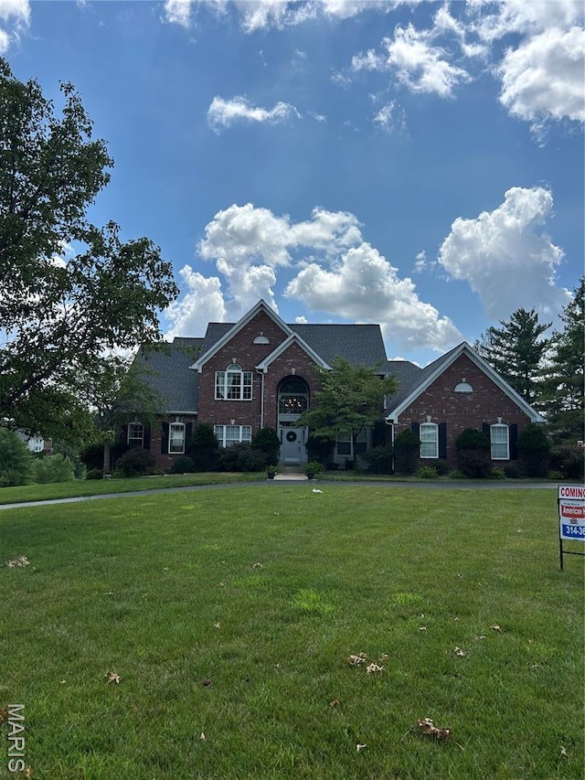 view of front facade featuring a front lawn and brick siding