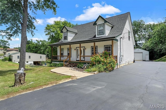104 Miller Dr, Fenton, MO 63026 - cape cod house with a porch, an outbuilding, a detached garage, a front lawn, and a shingled roof