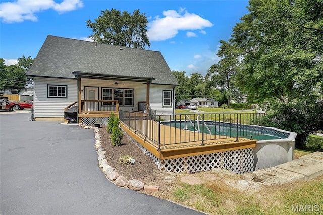 104 Miller Dr, Fenton, MO 63026 - back of house with an outdoor pool, a deck, and a shingled roof