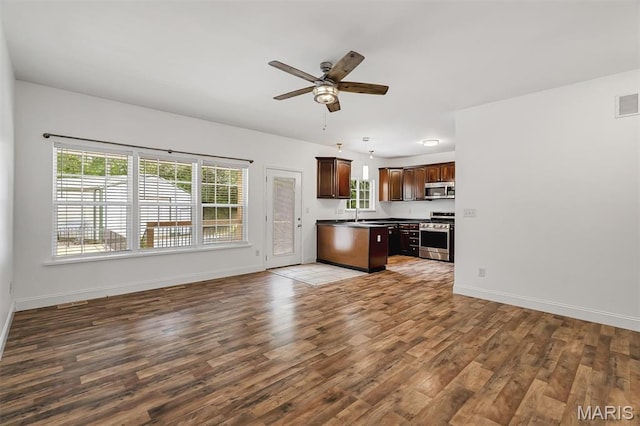 104 Miller Dr, Fenton, MO 63026 - kitchen featuring open floor plan, stainless steel appliances, wood finished floors, a ceiling fan, and dark brown cabinetry