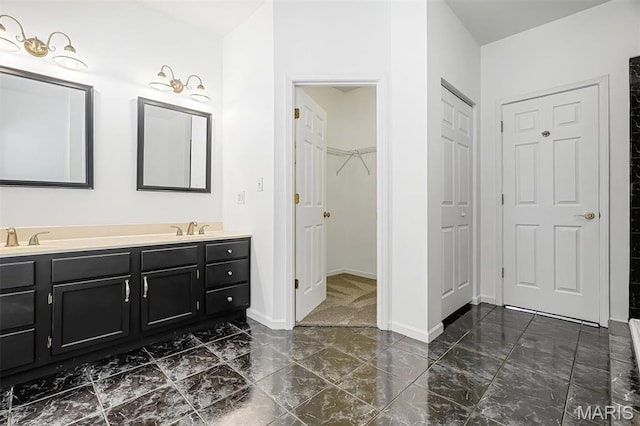 104 Miller Dr, Fenton, MO 63026 - bathroom with marble finish flooring, double vanity, and a walk in closet