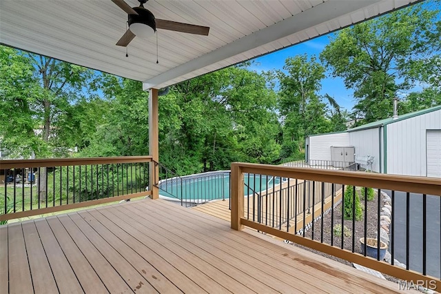 104 Miller Dr, Fenton, MO 63026 - wooden deck featuring ceiling fan, an outdoor pool, and view of wooded area