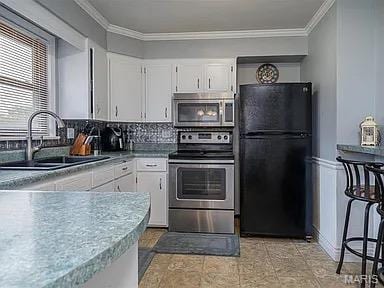 4840 S Point Rd, Washington, MO 63090 - kitchen with stainless steel appliances, ornamental molding, white cabinetry, tasteful backsplash, and light countertops