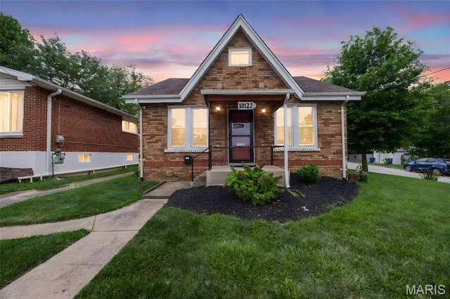 10122 Niblic Dr, Saint Louis, MO 63114 - bungalow-style house with a yard and brick siding