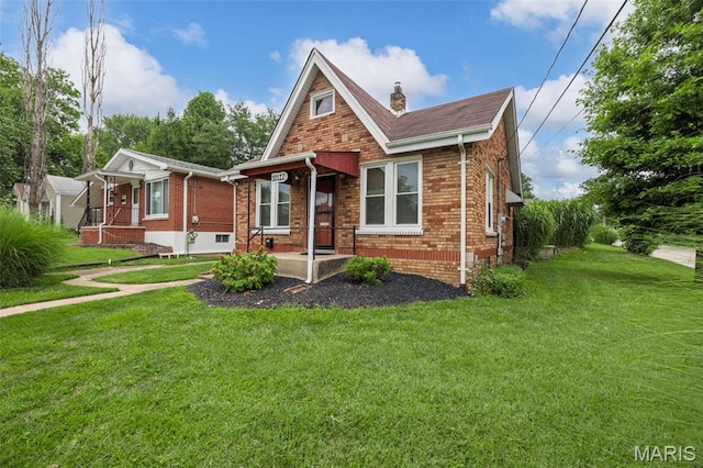 10122 Niblic Dr, Saint Louis, MO 63114 - view of front of property with brick siding, a front yard, a chimney, and covered porch